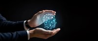 Businessman in suit holding glowing digital brain with neural network connections, symbolizing artificial intelligence and machine learning innovation.