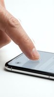 Close-up of male hand with finger touching smartphone screen on white background. Isolated for app development, technology, and digital interface design use.