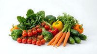 Fresh organic vegetables including tomatoes, carrots, peppers, cucumbers and leafy greens arranged on white background for healthy cooking and nutrition.