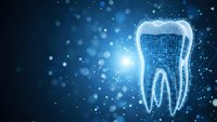 Digital tooth wireframe model glowing on blue background with bokeh lights for dental technology and healthcare innovation concepts.