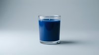 Blue candle in clear glass holder on white background, isolated for design projects and home decor concepts.