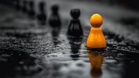 Orange wooden game piece stands out against black and white background with water droplets, symbolizing leadership, uniqueness and standing apart from crowd.