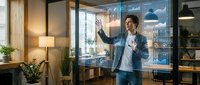 Young Caucasian male professional interacting with a futuristic holographic data dashboard in a modern office, showcasing advanced analytics technology.
