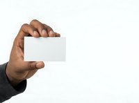 Male hand holding blank white business card isolated on white background for corporate branding and marketing presentations.