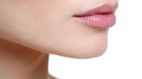Close up view of natural pink lips and smooth skin on light background showing feminine beauty and skincare results. Suitable for cosmetic and beauty advertising.