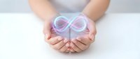 Hands holding glowing infinity symbol representing endless possibilities, eternal love, and limitless potential in business and personal growth concepts.
