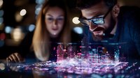 Young diverse professionals examining futuristic holographic city projection with glowing buildings and digital infrastructure in dark office environment.