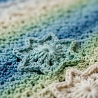 Colorful gradient crochet blanket with intricate stitching patterns in blue green and cream tones showcasing handmade textile craftsmanship and cozy home decor.