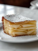 Layered apple dessert slice dusted with powdered sugar on white plate, showing delicate layers of thinly sliced fruit in flaky pastry crust, macro food photography.