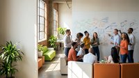 Diverse business team collaborating on strategy planning in modern office with whiteboard brainstorming session and natural lighting.