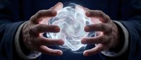 Male hands cupping glowing white energy sphere with swirling light effects against dark background for spiritual healing meditation and power concepts.