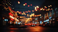 Defocused urban night street with colorful bokeh lights creating magical atmosphere for festive or romantic backgrounds.