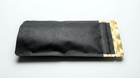 Black fabric pouch with golden metal clasp closure isolated on white background for luxury accessories and fashion design projects.