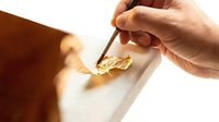 Caucasian male hand holding tweezers, extracting gold nugget from white surface, precious metal mining and refining concept for finance and wealth themes.