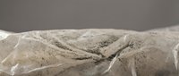 Dramatic rocky mountain landscape with snow-covered peaks and deep valleys under moody overcast sky for outdoor adventure and nature themes.