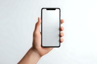 Hand holding modern smartphone with blank white screen mockup against neutral background for app presentation and mobile interface design.