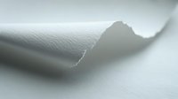 Curled edge of white paper creating soft shadow and depth effect against light background, minimalist composition for design and presentation backgrounds.