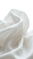 Soft white fabric with flowing folds and gentle waves, isolated on white background. Suitable for textile design, fashion backgrounds, and product mockups.
