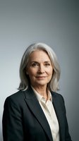 Senior woman with long gray hair wearing dark blazer and white shirt, professional headshot against neutral background for corporate, business, and executive use.