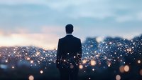 Silhouette of businessman overlooking city lights at dusk, bokeh effect creates magical atmosphere. Concept of leadership, success and urban opportunity.