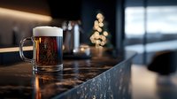Fresh dark beer with foam head in glass mug on wooden bar counter in modern pub interior with warm ambient lighting for hospitality and beverage concepts.