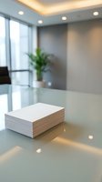 Stack of blank white paper documents on modern glass conference table in bright corporate office meeting room with natural lighting and plant decor.