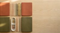 Colorful notebooks and wooden pencils arranged symmetrically on light wood surface for creative workspace and stationery design projects.