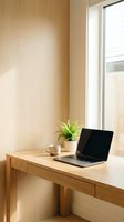 Minimalist wooden home office workspace with laptop, coffee cup and green plant by window. Modern remote work setup for productivity and focus.