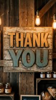 Rustic wooden thank you sign with gold and teal lettering displayed in vintage bakery setting with hanging Edison bulbs, shelving, and artisan bread products.