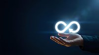 Businessman hand holding glowing infinity symbol against dark blue background, representing endless possibilities, sustainable growth, and continuous improvement for corporate concepts.