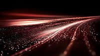 Abstract red light trails and glowing particles flowing on black background create dynamic motion perspective for technology and digital concepts.