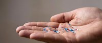 Handful of colorful prescription pills and capsules in open palm representing medication, healthcare treatment, pharmaceutical therapy and medical care.