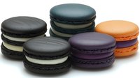 Colorful French macarons in various flavors including chocolate, lavender, orange and mint isolated on white background for bakery and dessert designs.