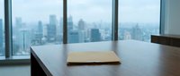 Modern office conference room with wooden table and city skyline view through floor-to-ceiling windows for business meetings and corporate presentations.