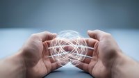 Hands protecting glowing network sphere with interconnected lines representing digital connectivity, data protection, cybersecurity and technology innovation concepts.