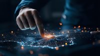 Finger touching digital network with glowing connection points and orange light particles on dark background, representing digital transformation.