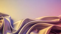Smooth flowing silk fabric with golden and purple gradient waves creating elegant abstract texture for luxury design backgrounds.