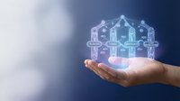 Human resources management concept with hand holding glowing network of connected employee icons representing team organization and workforce planning.