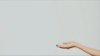 Female hand with manicured nails extended in offering or receiving gesture against minimalist light gray background, creating clean negative space for design projects.
