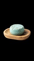Solid shampoo bar with herbs on a wooden soap dish, isolated on transparent background, ready for stickers, print on demand, and T-shirt design use.
