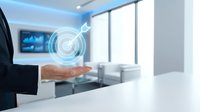 Businessman hand presenting holographic digital interface in modern office space with futuristic technology concept for business presentations.