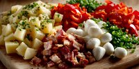 Fresh ingredients arranged on wooden board with diced potatoes, bacon, red peppers, mozzarella balls, and chopped herbs for gourmet cooking preparation.