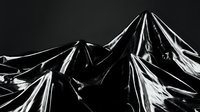 Black glossy plastic material with dramatic folds and creases creating abstract sculptural forms against dark background for modern design projects.