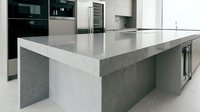 Modern kitchen island with gray and white quartz countertop, sleek cabinetry, and integrated appliances for contemporary home design and interior renovation projects.