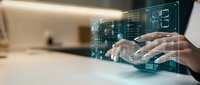 Businessman hands typing on laptop with holographic digital interface displaying data analytics and futuristic technology overlay in modern office.