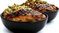 Grilled salmon fillet with brown rice and fresh vegetable salsa served in black ceramic bowl on white background, showcasing healthy meal presentation.