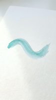 Minimalist turquoise watercolor wave brushstroke on white textured paper background for artistic design projects and creative applications.