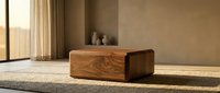 Solid wood coffee table with rounded edges in a warm minimalist living room, sunlight casting soft shadows on a woven rug.