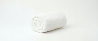 Rolled white towel on neutral background, isolated and ready for spa, hospitality, wellness, and bathroom product design applications.