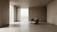 Minimalist interior space with concrete walls, polished floor, and modern curved furniture near large window with landscape view.